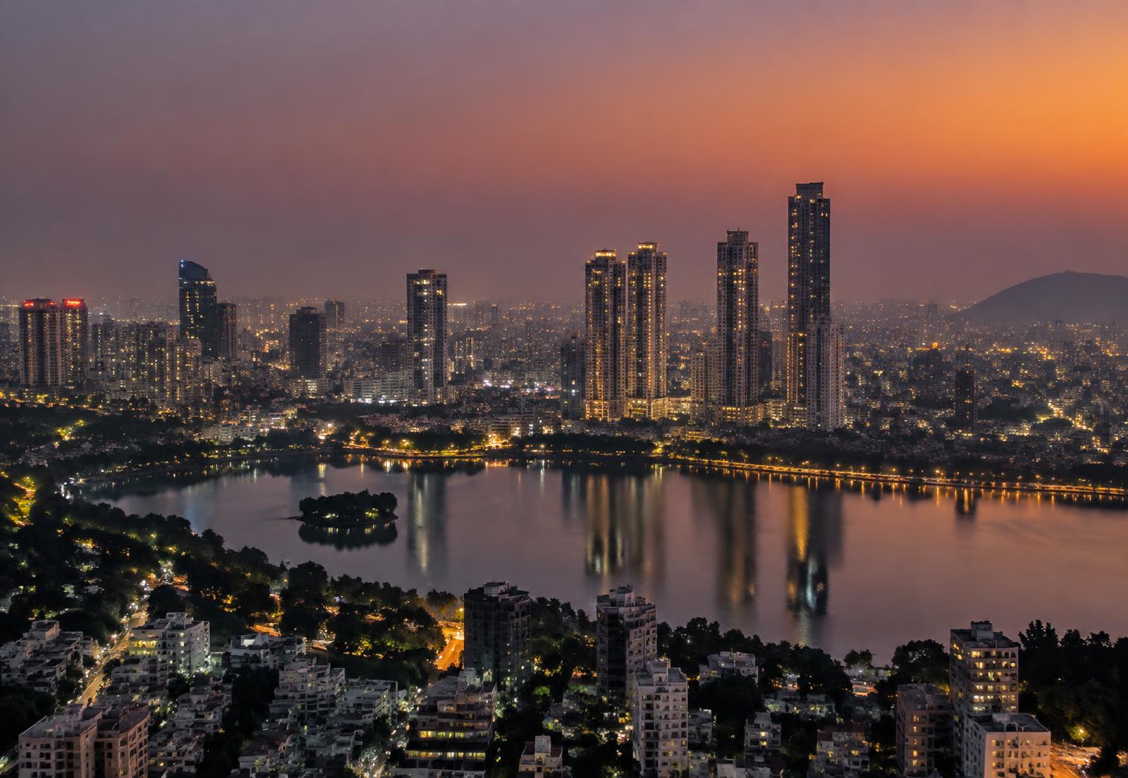 City skyline of glass residential and office towers at sunset
